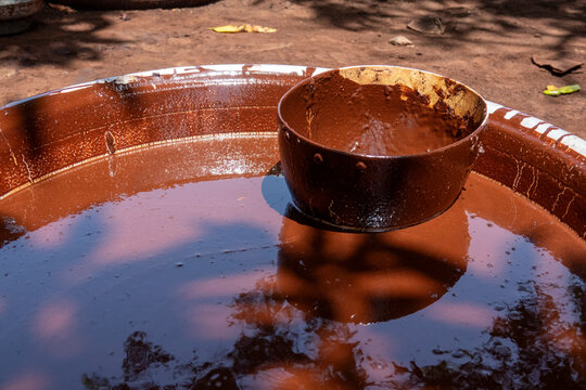 A metal bowl floats in a basin of shea butter paste at a karite processing site, Savanes district, Tcheregnimin, Ivory Coast