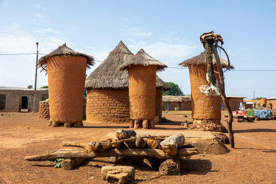 Adobe granaries with conical thatched roofs stand in a row in a Senufo village, Savanes district, Niofoin, Ivory Coast