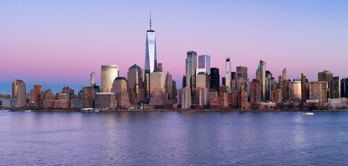 Naklejka premium NYC aerial panoramic skyline over downtown Manhattan at dusk. Manhattan panoramic New York City landscape with skyscrapers at dusk. Manhattan dusk panoramic skyline in New York.