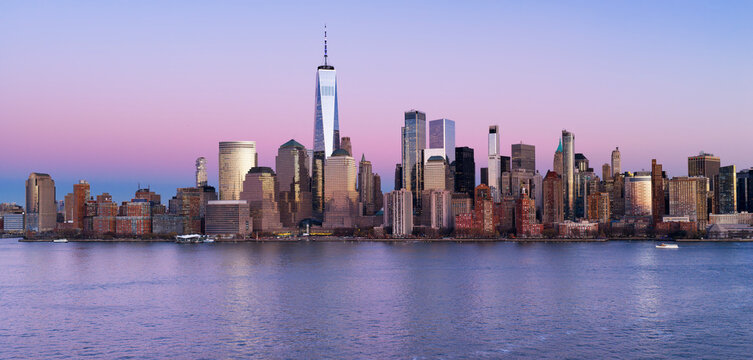 NYC aerial panoramic skyline over downtown Manhattan at dusk. Manhattan panoramic New York City landscape with skyscrapers at dusk. Manhattan dusk panoramic skyline in New York.
