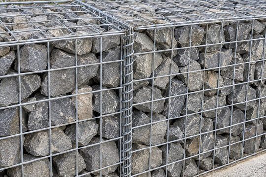 Gabion wall, steel mesh cages retaining angular stone