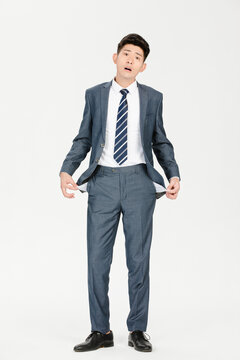 Worried businessman showing empty pockets in financial trouble