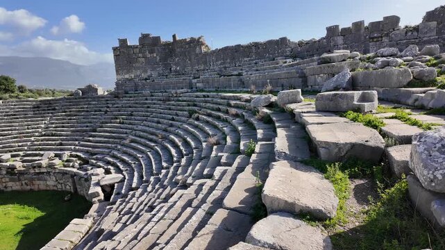 Ruins of the ancient Roman amphitheater at Xanthos in Lycia, Antalya, Turkey, with stone seating tiers.
