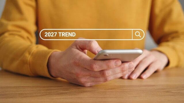 Person searching for 2027 trends on smartphone