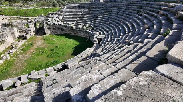 Xanthos ancient theater in Lycia, Antalya, Turkey. Semicircular stone seating of a historic Roman amphitheater.