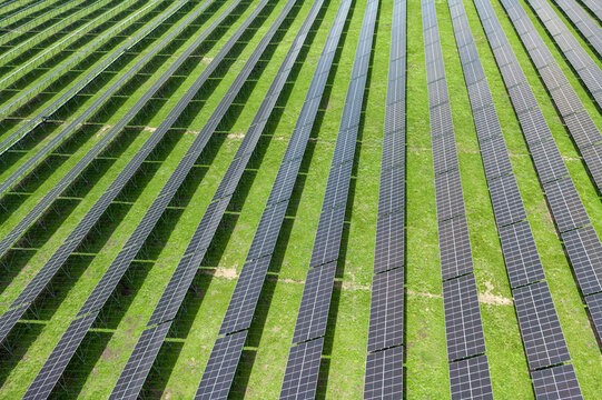 Top-Down Aerial Close-Up View of Solar PV Panel Array on Zoige Grassland: Renewable Clean Energy, Agrivoltaics, Green Field and Sunlight Background