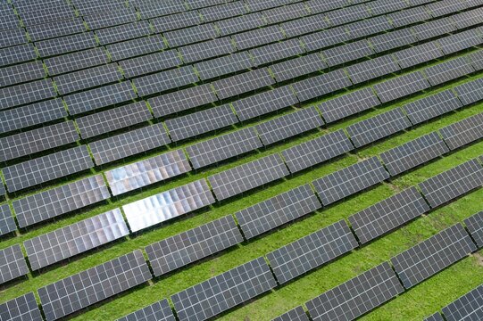 Top-Down Aerial Close-Up View of Solar PV Panel Array on Zoige Grassland: Renewable Clean Energy, Agrivoltaics, Green Field and Sunlight Background