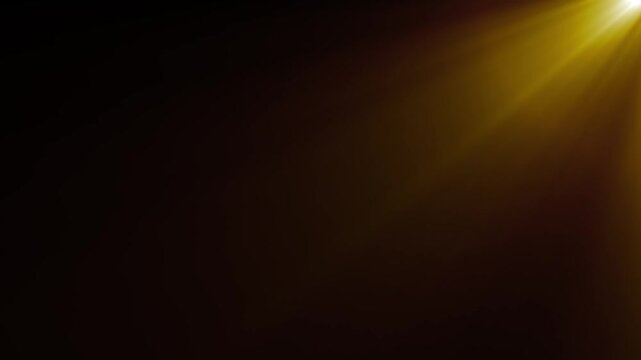 Warm golden light rays background animation on black screen. Soft sunbeam haze overlay and glowing spotlight transition effect video footage.