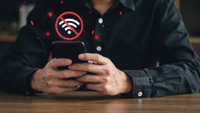 Person holding smartphone with no internet connection icon