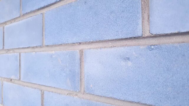 Brick construction. A brick wall made of dark blue bricks.