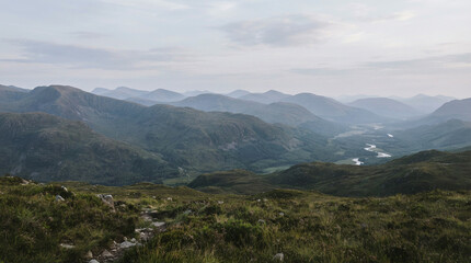Fototapeta premium Elevated view of forested hills and a river winding through a valley in daylight