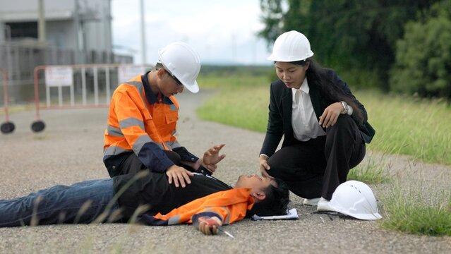 Workplace Accident Emergency with Engineers Giving First Aid to Unconscious Worker on Site Road 4K