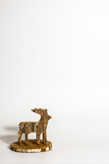 Rustic Wooden Reindeer Christmas Decoration on Wood Slice with Copy Space © Wendy