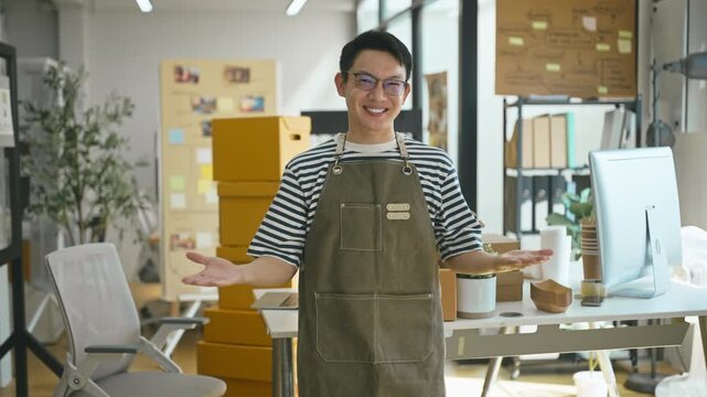 Portrait of confident Asian SME owners in shop.
