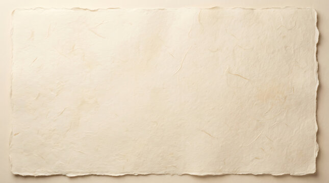 Handmade ivory paper sheet with rough deckled edges and textured surface