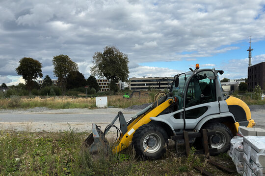 Construction loader parked near a building site in a city