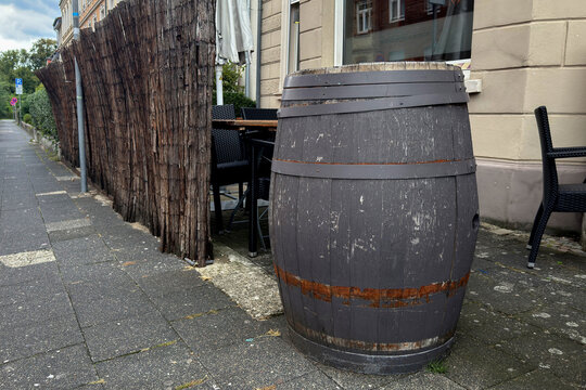 Wooden barrel placed outside a cafe along the sidewalk
