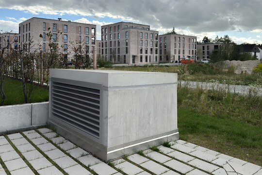 Modern building complex with a grey concrete ventilation structure