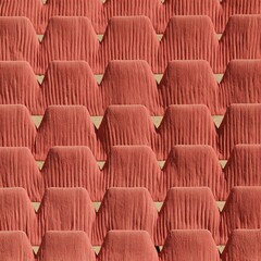 Fototapeta premium Warm coral folding chairs arranged in a symmetrical pattern on a driveway, featuring hard-edged lighting and textured fabric for event planning
