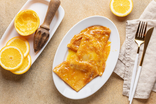 Delicious crepes suzette with orange syrup on plate. La Chandeleur. French cuisine