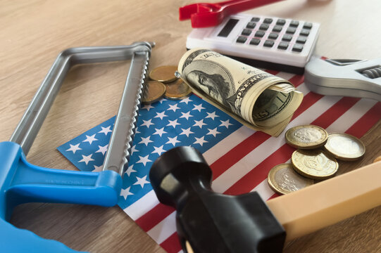 financial tools arranged on an american flag in a practical top-down perspective, business and finance scene with metal, paper, and plastic objects, clean indoor setting, blue and silver.