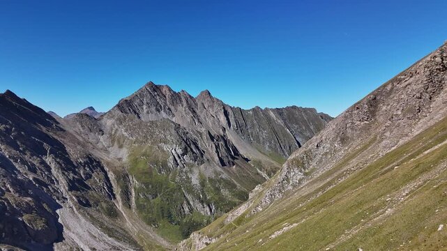 ⁠Majestic alpine mountain peaks and deep valley in the Alps, aerial drone view⁠