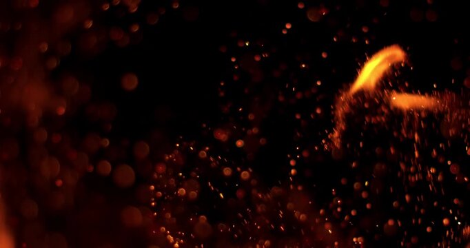 Ultra slow motion fire flames with glowing embers and sparks on black background captured at 1000 FPS. Dramatic combustion effect ideal for cinematic overlays and visual effects.
