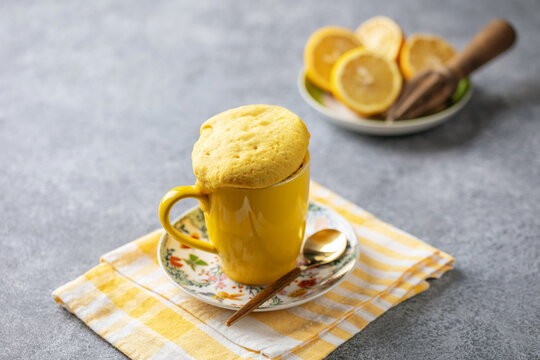 Lemon cupcake in a yellow mug. Easy homemade dessert. Mug cake