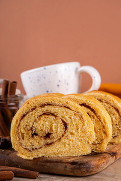 Sourdough Pumpkin Cinnamon Swirl Bread.  Cinnamon roll bread loaf bun with pumpkin puree based dough, tasty sweet cinnamon swirls, on beige background copy space