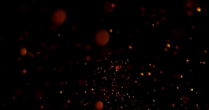 Ultra slow motion floating embers and glowing sparks on black background captured at 1000 FPS. Atmospheric fire particles drifting through darkness, ideal for cinematic overlays.