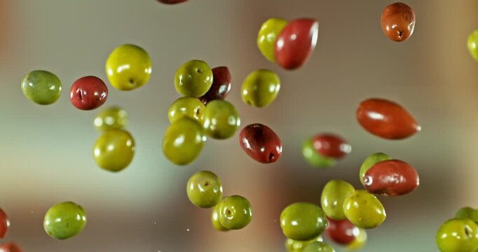 Super Slow Motion of Flying and Rotating Green and Black Olives. Filmed on High Speed Cinema Camera, 1000 fps. Speed Ramp Effect.