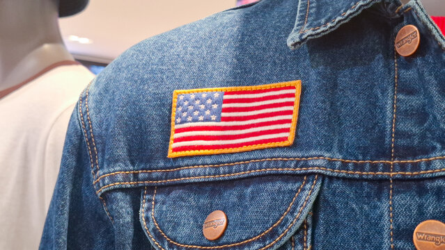 Wrangler Denim Jean Jacket Featuring Embroidered American Flag Patch Displayed On Mannequin Editorial Illustrative on August 27, 2026 in Bangkok,  Thailand 