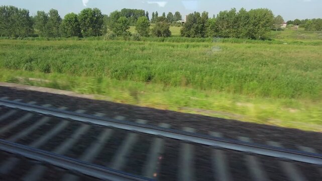 Europe, Italy , Milan 09,17,2026  - Frecciarossa  Hight speed 300km h train railway from Milan  to Rome and Naples   -  looking out the train window, the faster way to travel in Italy for tourist and 