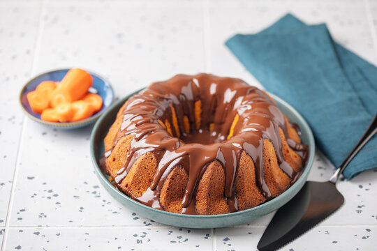 Brazilian carrot cake, bolo de cenoura, with chocolate glaze on the plate. Dessert, baked, delicious.