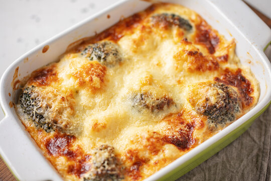 Casserole Cauliflower and Broccoli baked with cheese sauce in a pot  on the table. Broccoli gratin.