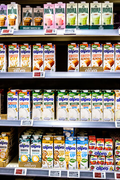 Waitrose Supermarket Display Of Cartons Of Plant-Based Milk Alternatives By Moma and Alpro