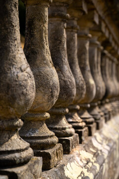 Close-up of the historic stone balustrade at Castle Howard in North Yorkshire, England, with weathered surfaces, repeating forms and shallow depth of field illuminated by warm summer sunlight.