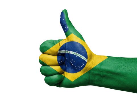 Hand with brazil flag painted on it giving a thumbs up gesture isolated on transparent background