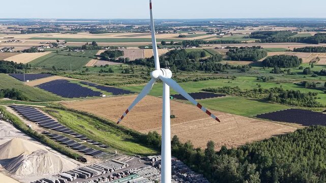 Sunrise over sustainable wind and solar energy farm