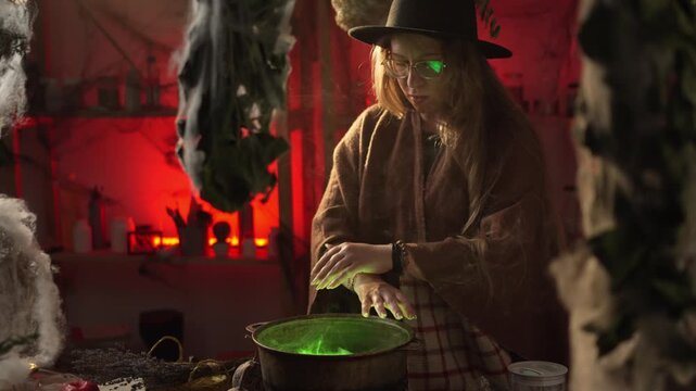 A realistic witch brewing a potion. She waves her hands over a steaming cauldron and recites a spell. Everyday life intertwined with traditional witchcraft. Magic and a mystical atmosphere.