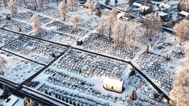 Large cemetery landscape with snow and winding paths