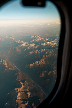 Aerial view of mountains from airplane window, atmospheric travel background