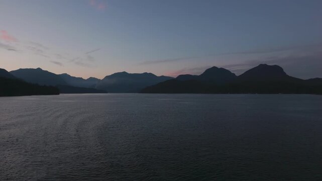 sunset over the mountains and ocean in British Columbia, Canada from a BC Ferries ship travel and tourism