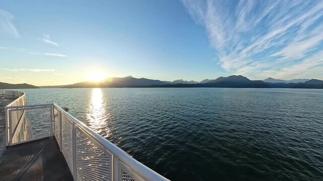 Rounding Gambier Island on Howe Sound from a ferry or ship at golden hour travel and tourism