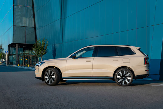 Kyiv, Ukraine - August 20, 2026: New Volvo EX 90 electric car near blue modern building