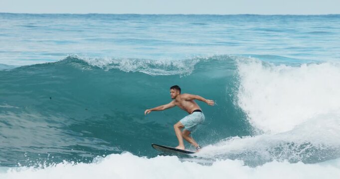 Surfer man rides on ocean wave. Summer surfing