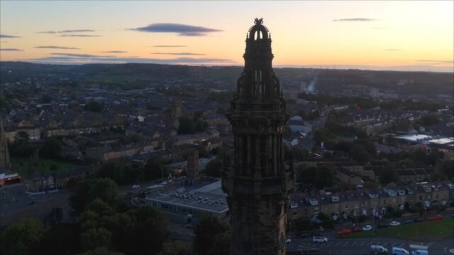 Sunset time-lapse orbiting Wainhouse Tower with traffic and cloud motion, Halifax, West Yorkshire