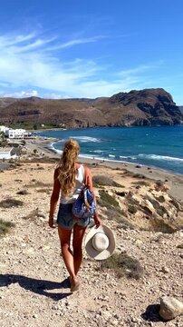Woman Walking Towards Las Negras Beach in Cabo de Gata Spain Discovering Scenic Coastal View