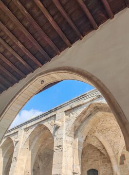 ​Ancient stone archways and wooden ceiling architecture at Saint Lazarus Church in Larnaca