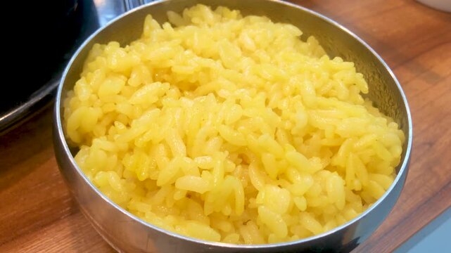 Freshly cooked turmeric rice in a bowl.